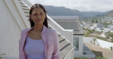 Woman Enjoying Sunshine on Rooftop with Scenic Views