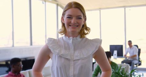 Confident Young Businesswoman Standing in Modern Office