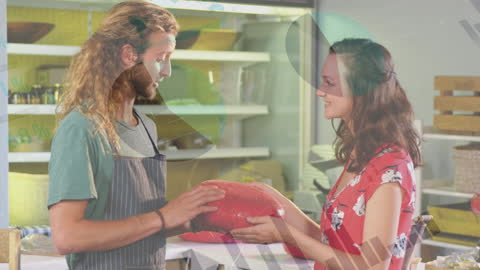 Shopkeeper Discussing Large Cheese with Smiling Customer