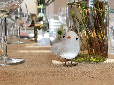 Rustic table setting with decorative bird on burlap