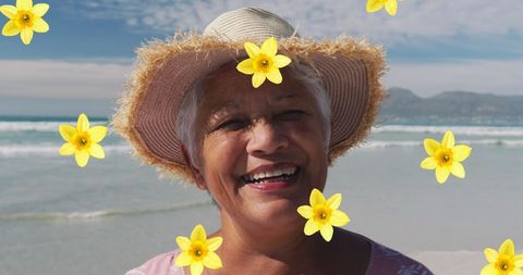 Joyful Senior Woman Smiling Amidst Floral Overlay at Beach