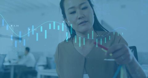 Businesswoman analyzing digital finance charts in modern office