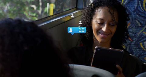 African American Woman Engaging with Social Media on Bus
