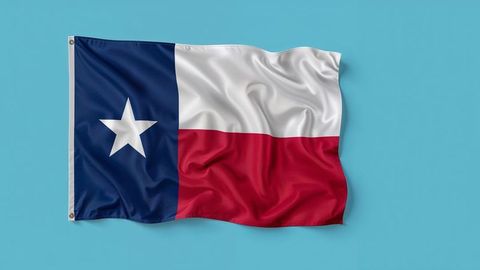 Waving Texas Flag Against Clear Sky Backdrop