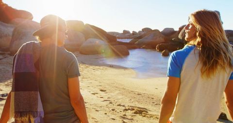 Friends Enjoying a Scenic Beach Walk at Sunset