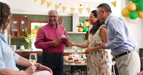 Senior Man Celebrating Birthday with Friends at Home Gathering