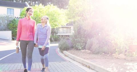 Mother and Daughter Enjoying Leisurely Walk in Suburban Neighborhood
