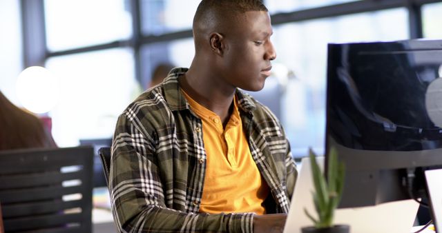 Focused Young Professional Working on Desktop Computer in Modern Office - Download Free Stock Images Pikwizard.com