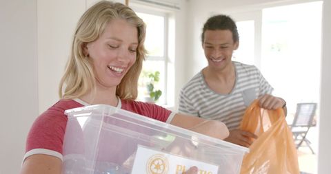 Happy Couple Recycling at Home for Eco-Friendly Living