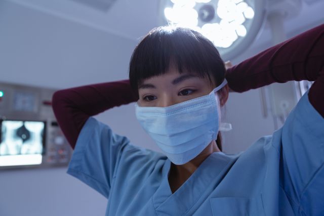 Female surgeon wearing surgical mask in operation room at hospital - Download Free Stock Photos Pikwizard.com