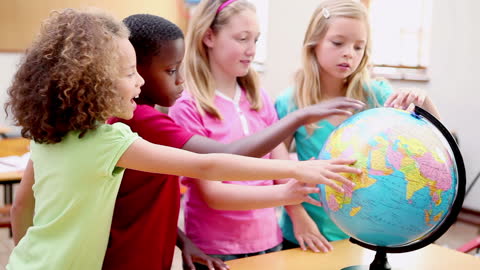 Diverse Children Exploring Geography with Globe in Classroom