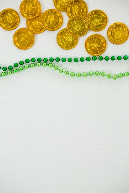 St Patricks Day gold chocolate coin and beads - Download Free Stock Photos Pikwizard.com