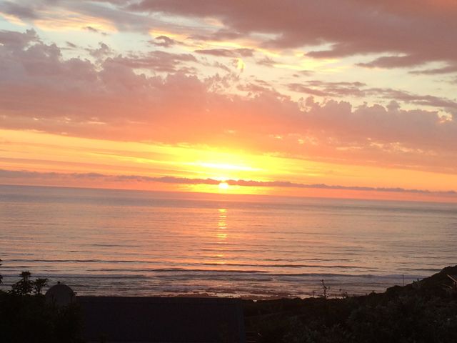 Beautiful Orange Sunset Over Calm Ocean With Cloudy Sky - Download Free Stock Photos Pikwizard.com