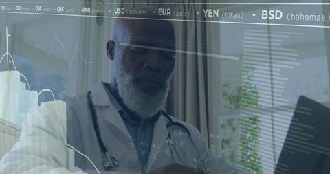 Senior physician reviewing medical and financial analytics on laptop in daylight office