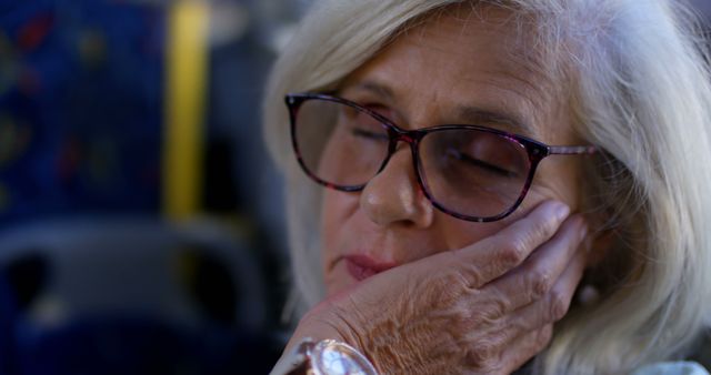 Elderly Woman Resting with Closed Eyes During Transportation - Download Free Stock Images Pikwizard.com