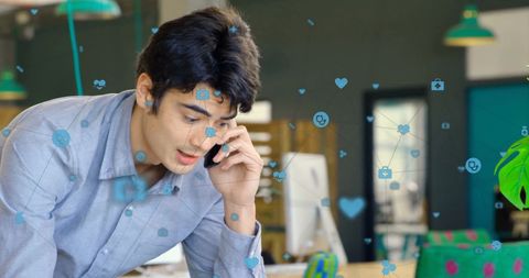 Man Utilizing Smartphone in High-Tech Office Setting