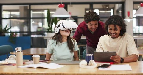 Students Exploring Virtual Reality While Collaborating in Modern Bright Coworking Space