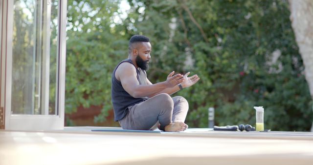 Focused man practicing stretching exercises for fitness on outdoor deck - Download Free Stock Images Pikwizard.com