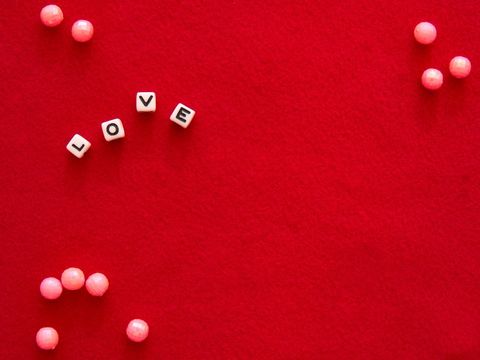 Love and affection symbolized by beads on red background