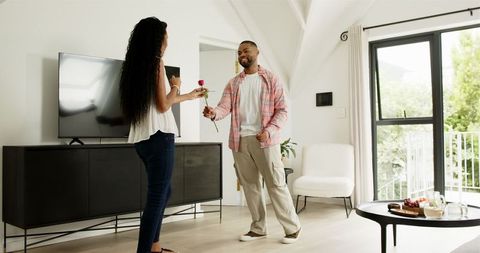 Romantic Proposal at Home with Red Rose and Engagement Ring