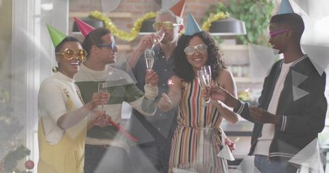 Diverse friends celebrating New Year party at home with champagne toasts and sparklers