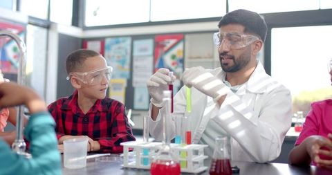 Curious Students Observing Chemistry Experiment in Classroom