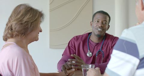Senior Couple Conversing Comfortably with Caring Doctor