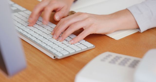 Caucasian female hands writing on white computer keyboard in office. Indoors, office, feminity, technology, communication, business, unaltered.