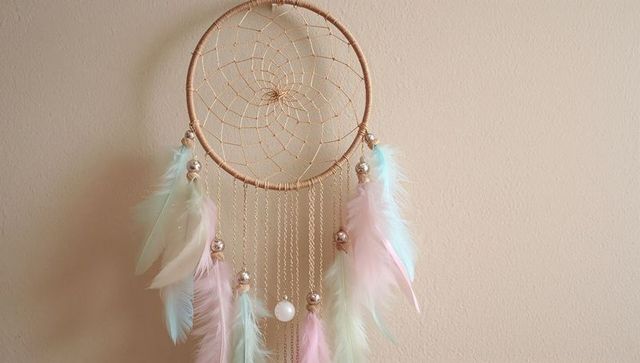 Pastel dreamcatcher with feathers and gold chains decor