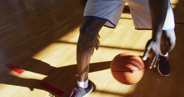 African american male basketball player practicing dribbling ball - Download Free Stock Photos Pikwizard.com