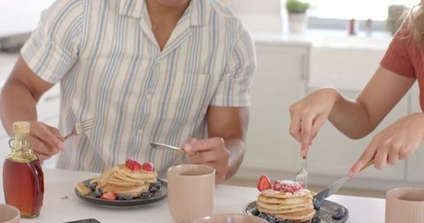 Couple Enjoys Breakfast with Pancakes and Fresh Strawberries
