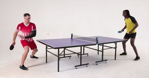 Dynamic table tennis match between focused athletes