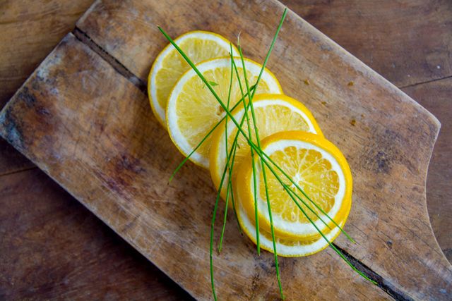 Fresh Lemon Slices with Chives on Rustic Wooden Board - Download Free Stock Photos Pikwizard.com