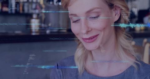 Woman Engaging with Digital Interfaces in a Relaxed Café Setting