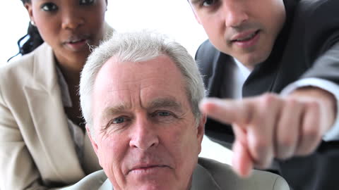 Focused Business Team Analyzing Screen in Bright Office