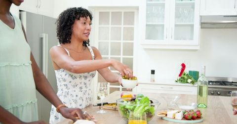Friends Preparing Fresh Salad in Modern Kitchen