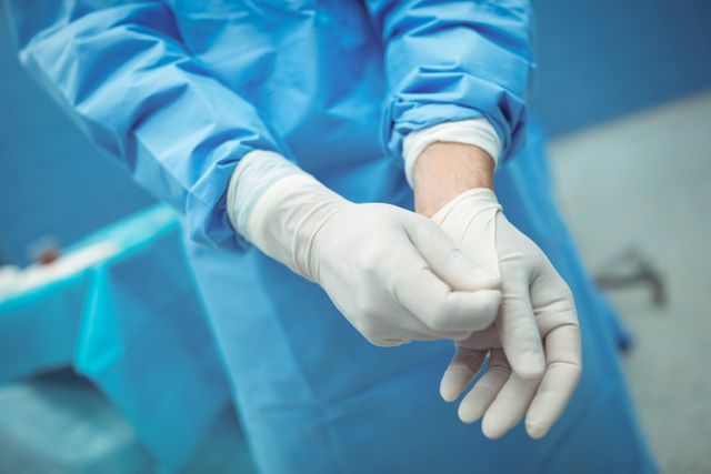 Surgeon Removing Surgical Gloves in Operating Room - Download Free Stock Photos Pikwizard.com