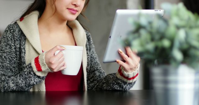 Woman Drinking Coffee and Using Tablet in Cozy Setting - Download Free Stock Images Pikwizard.com