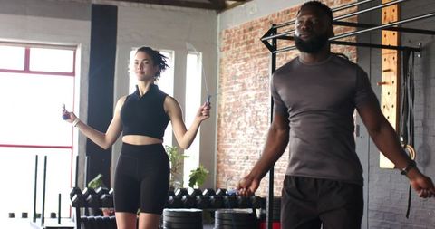 Diverse Training Partners Enjoying Cardio Workout at Gym