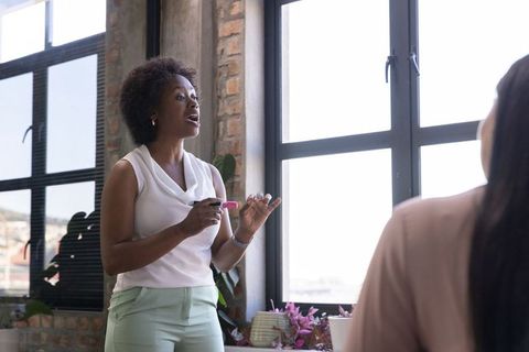 Professional female leader presenting in modern office