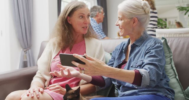 Senior Women Sharing Digital Tablet on Living Room Couch - Download Free Stock Images Pikwizard.com