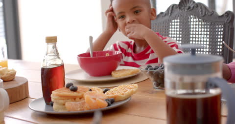 Child Enjoying Breakfast in Bright Kitchen Setting