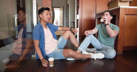 Diverse Male Couple Relaxing and Enjoying Coffee at Home