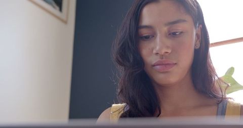 Teenage Girl Focused on Laptop Work at Home