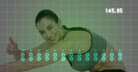 Smiling fit woman giving thumbs-up performing forward bend with digital health overlay