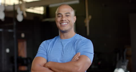 Confident Athlete Smiling in Gym Environment