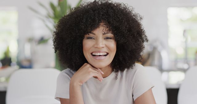 Smiling Woman with Curly Hair Relaxing at Home - Download Free Stock Images Pikwizard.com