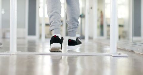 Person with Disability Walking on Parallel Bars in Rehabilitation Center