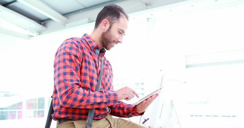 Man Engaged with Tablet in Modern Workplace