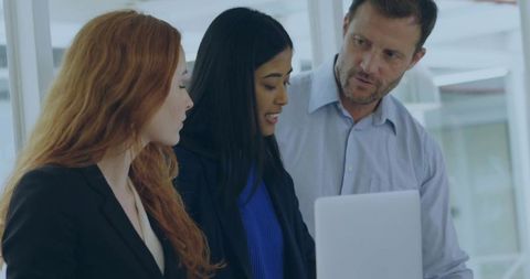 Collaborative Team Analyzing Report in Modern Office Setting